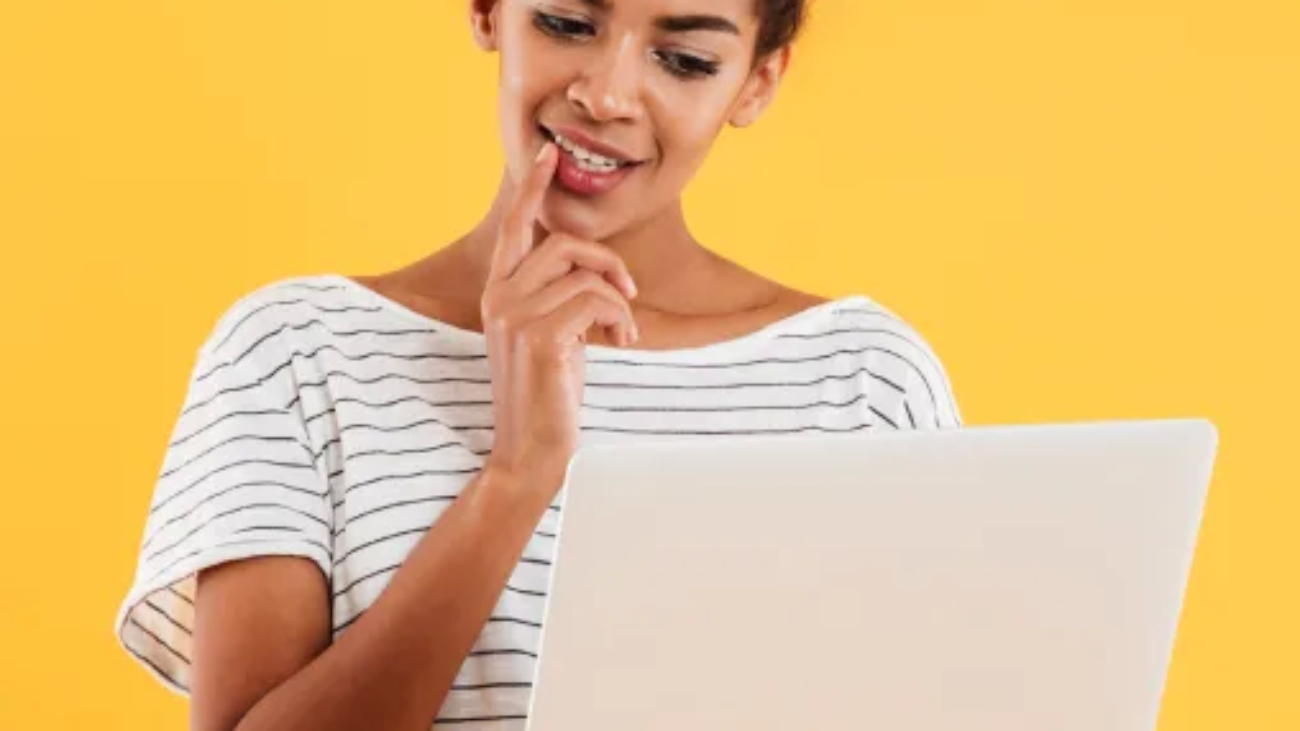 young-positive-cool-lady-with-curly-hair-using-laptop-isolated